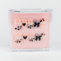 Buy Ribbons & Shadows press on nails in Squaoval shape, Party theme, nude,black colour and Long length.
